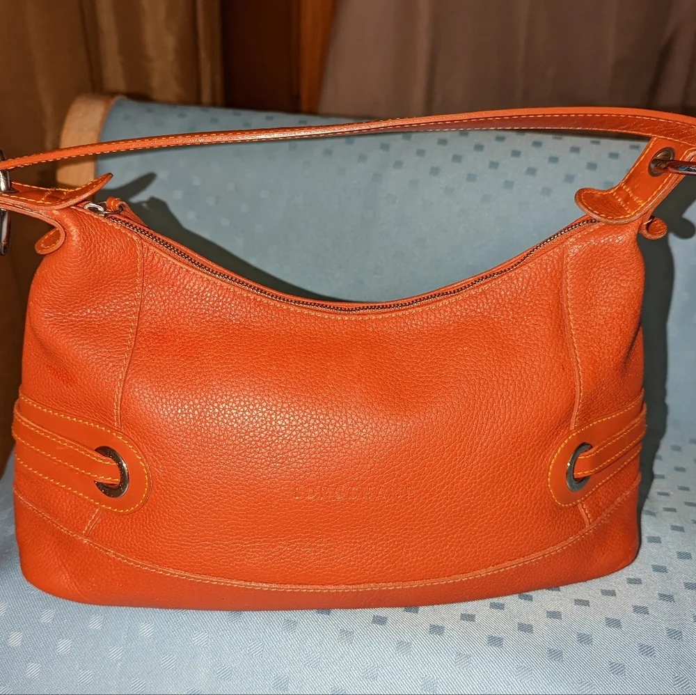 Longchamp orange leather shoulder bag.